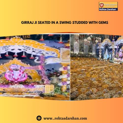 Girraj Ji seated in a swing studded with gems.png