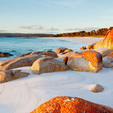 Red lichen covered rocks on beach, Bay of Fires, Tasmania, Australia 1080p