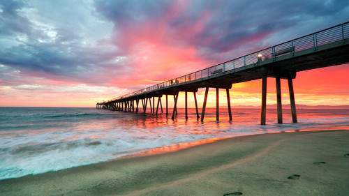 Footprints in the beach sand under a pier, Hermosa Beach, Los Angeles, California, USA 1080p