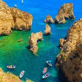 Fishing boat on turquoise sea water at Ponta da Piedade, Algarve region, Portugal 1080p