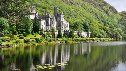 View from water at Kylemore Abbey near trees, Connemara, County Galway, Ireland 1080p.jpg