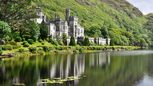 View from water at Kylemore Abbey near trees, Connemara, County Galway, Ireland 1080p