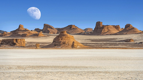 Dasht e Lut (Lut or Kalut) desert with full moon above horizon, Iran 1080p