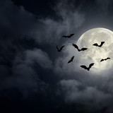 Dramatic Halloween sky with full moon and bats silhouette