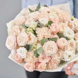 Mono bouquet of spray roses. Delicate bouquet of mixed flowers in womans hands. the work of the flor