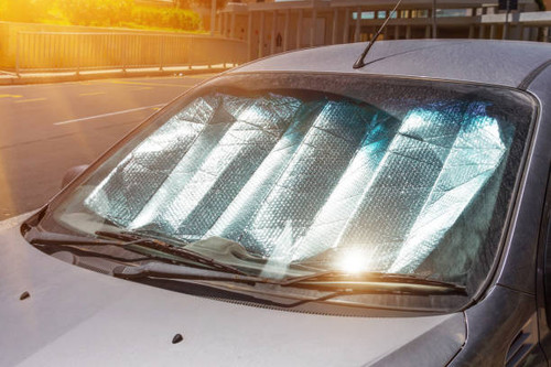 Protective reflective surface under the windshield of the passenger car parked on a hot day, heated .jpg