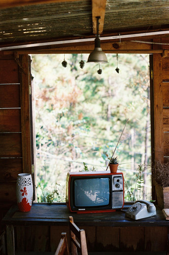 free photo of vintage tv and telephone on table in window.jpg