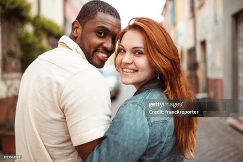 interracial couple walking in the street together.jpg