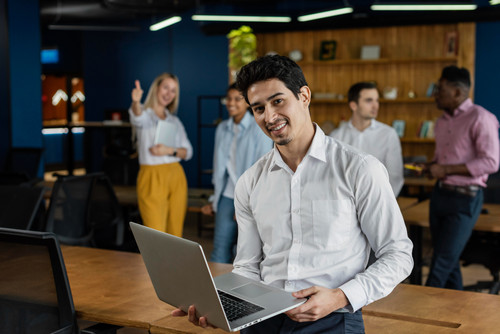 smiley man work holding laptop posing (1).jpg