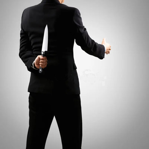 knife man suit holding knife behind back isolated grey background 40983930.jpg