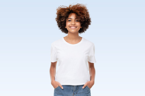 Front view of african american girl standing with hands in pockets, wearing blank t-shirt with copy .jpg