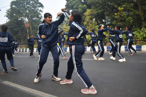School girls are performing martial arts during a rehearsal for the Republic Day parade on a winter .jpg