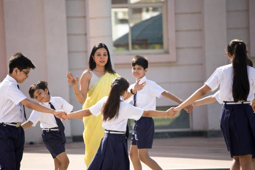 Teacher playing with students in campus.jpg