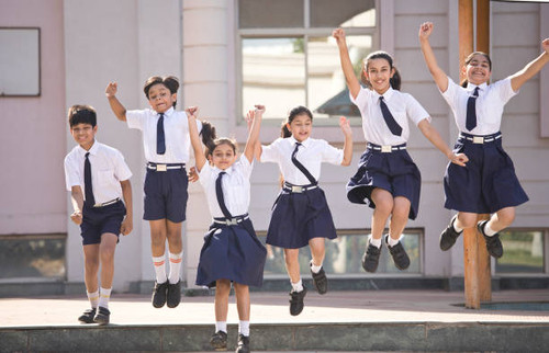Schoolboys and schoolgirls jumping and celebrating in school campus.jpg