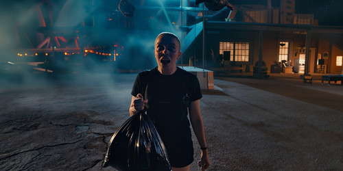 A surreal darkly comedic cinematic scene in a desolate middle of nowhere area where a person stands .jpg