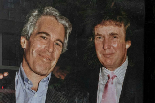 commuters walk past a bus stop near nine elms station as activists put up a poster showing president.jpg