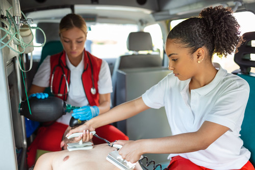 Paramedic using defibrillator (AED) in conducting a basic cardiopulmonary resuscitation. Emergency C.jpg