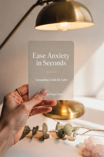 Zainab Lunje Hand holding printable affirmation card beside cozy desk lamp wit 6806c277 d1fd 4365 91.jpg