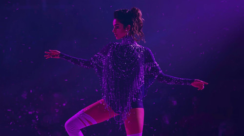 The lead Indian dance superstar steps into a world of ultraviolet glow, dressed in a daring deep pur.jpg