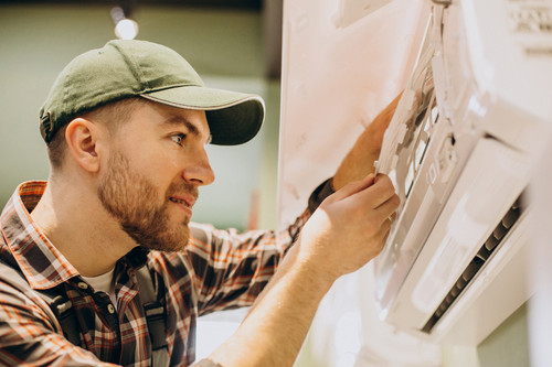 repairman doing air conditioner service.jpg