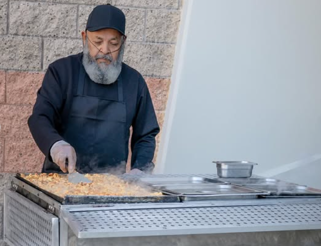 Chava preparing authentic Mexican tacos on the grill