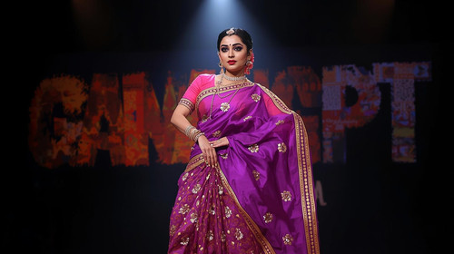 Marathi lavani style woman in seductive purple saree, dramatic eyebrow makeup, spotlight on stage; “.jpg