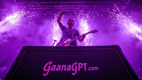 Kannada rockstar man on stage with purple pyrotechnics bursting; “GaanaGPT.com” engraved on the ampl.jpg