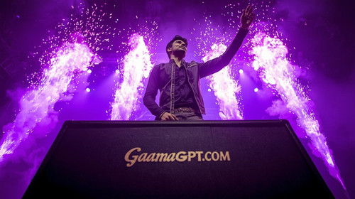 Kannada rockstar man on stage with purple pyrotechnics bursting; “GaanaGPT.com” engraved on the ampl.jpg