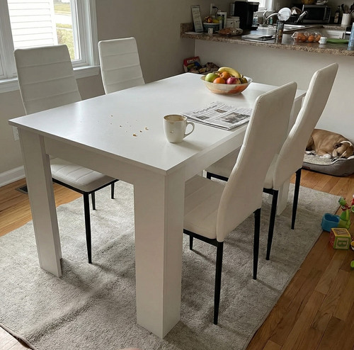 We stopped eating on the sofa after getting this white dining table and chairs set.jpg