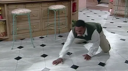 Carlton drags himself across the floor.webp