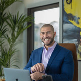 Nathan Levinson, Founder of Royal York Property Management, smiling in blue suit.