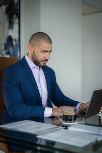 Nathan Levinson, Founder of Royal York Property Management, focused on laptop work..jpg