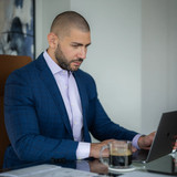 Nathan Levinson, Founder of Royal York Property Management, focused on laptop work.