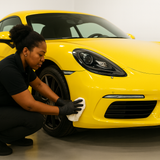 Black girl wiping a yellow car