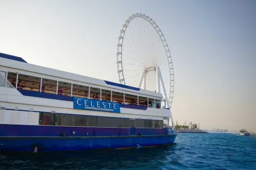 Best Dinner Cruise boat in Dubai Marina with Ain Dubai Ferris wheel in the background.webp