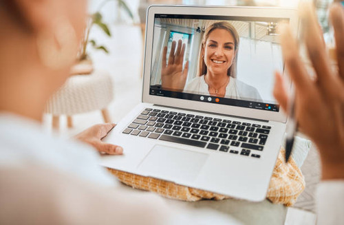 Laptop, video call and mental health with wave hello in virtual counseling consultation, doctor and .jpg