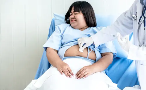 asian fat woman lying bed she was admitted treatment from diabetes where doctor was about inject vac