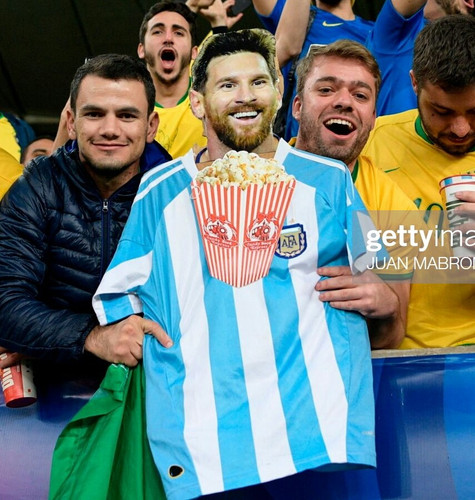 fans of brazil hold an image of argentine footballer lionel messi picture id1154511873 1.jpg