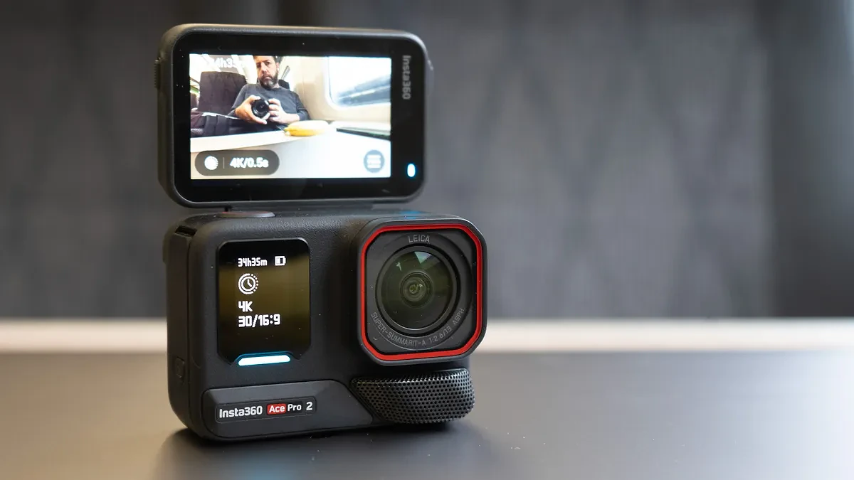 Insta360 Ace Pro 2 camera on a table with its screen up, lens facing me &ndash; you can see me taking a picture of the Ace Pro 2 in the screen.