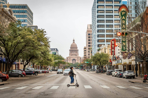 Austin woman riding scooter shutterstock 1570686892.jpg