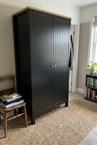 Using dark furniture as an anchor piece to pull a neutral bedroom together.png
