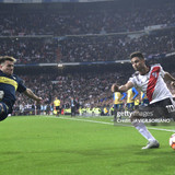 TOPSHOT - River Plate's Gonzalo Martinez is challenged by Boca Juniors' Julio Buffarini during the s