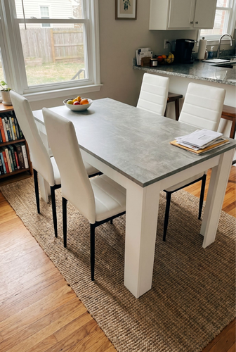 Grey marble dining room table and chairs with a fruit bowl centrepiece.2