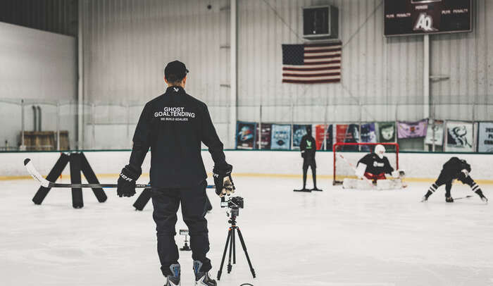 Dr. Jamie Phillips filming a goalie session at the rink