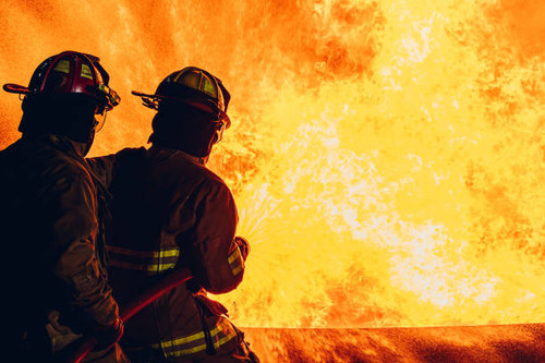 Firefighter Concept. Fireman using water and extinguisher to fighting with fire flame. firefighters .jpg