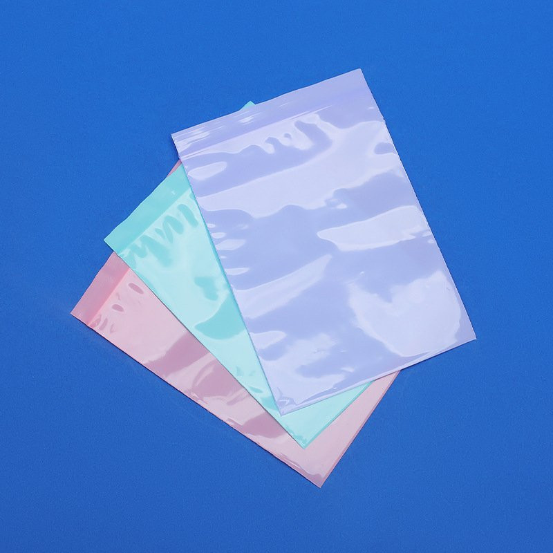 Coloured PE self-sealing bags in pink, green and purple showing masterbatch colouring
