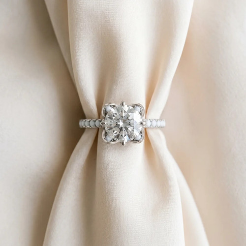 White-gold-Round-Cut-Diamond-Ring-with-Pav-Band-and-Floral-Prong-Setting.jpg