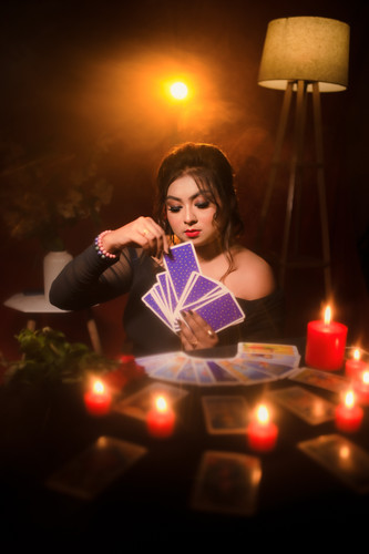 Priyadarsini Mallikk holding a fan of tarot cards