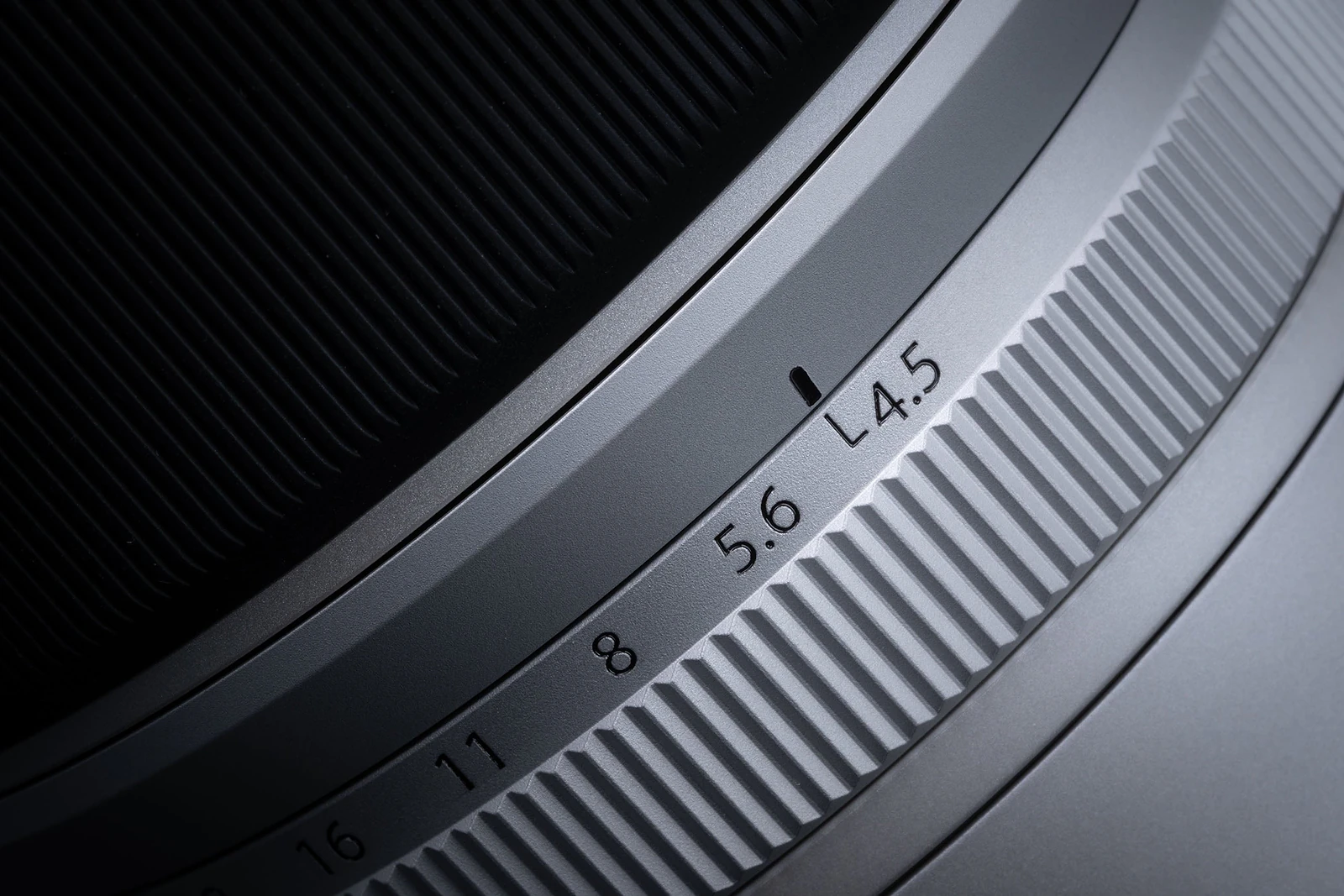 A close-up view of a camera lens barrel showing an aperture ring with markings for 4.5, 5.6, 8, 11, and 16, with a black indicator line set to 5.6.