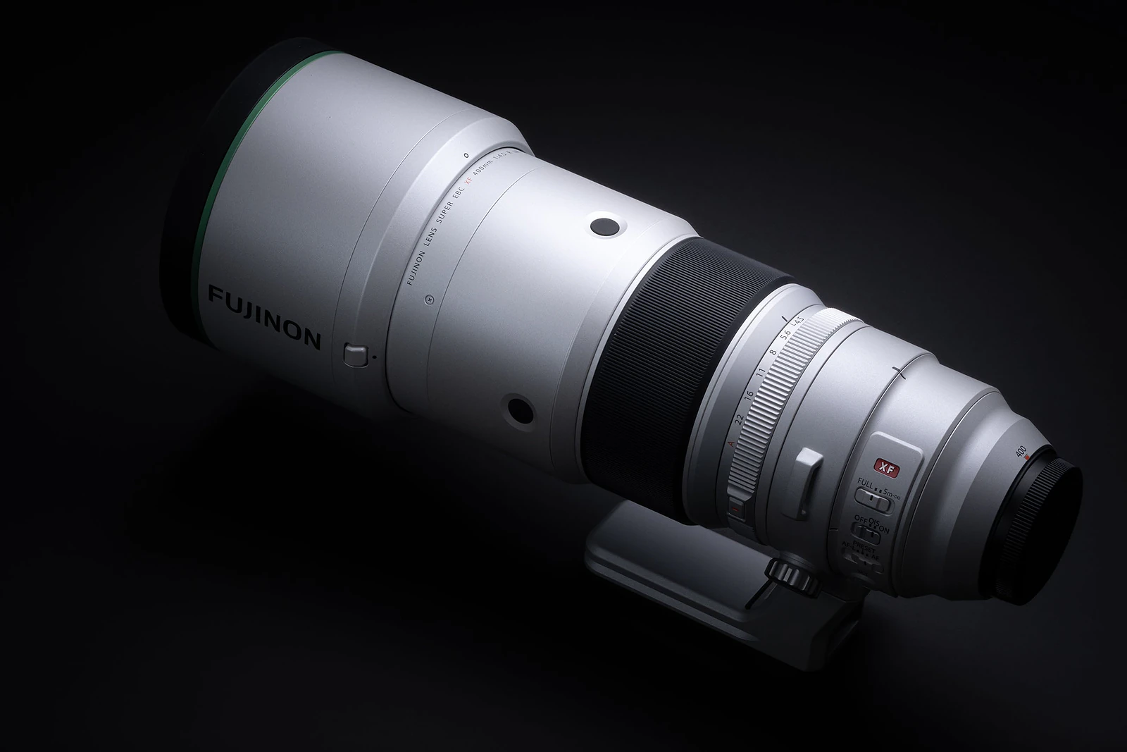 A silver Fujinon XF 400mm telephoto lens sits against a solid black background.